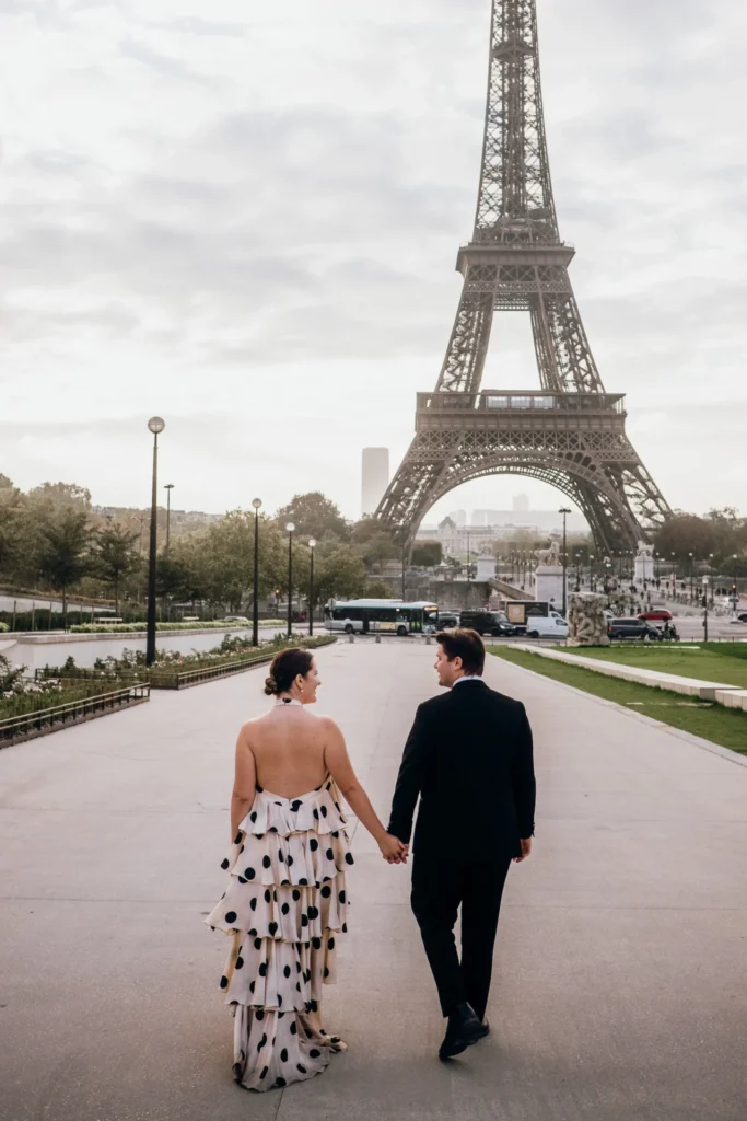 Elegant couple walking to the Eiffel Tower