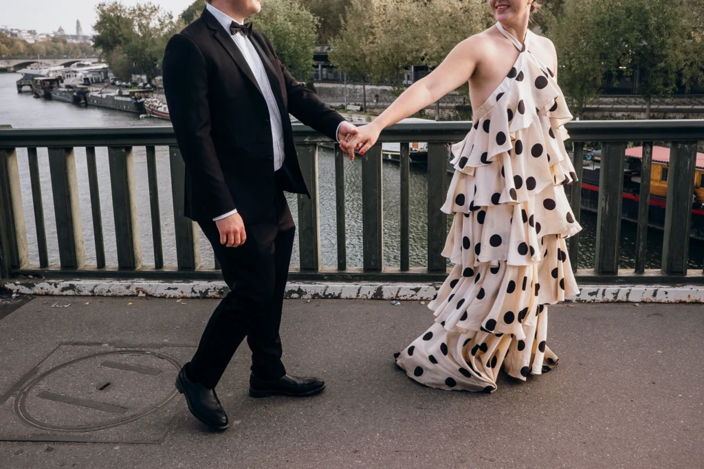 Elegant couple holding hands in Paris