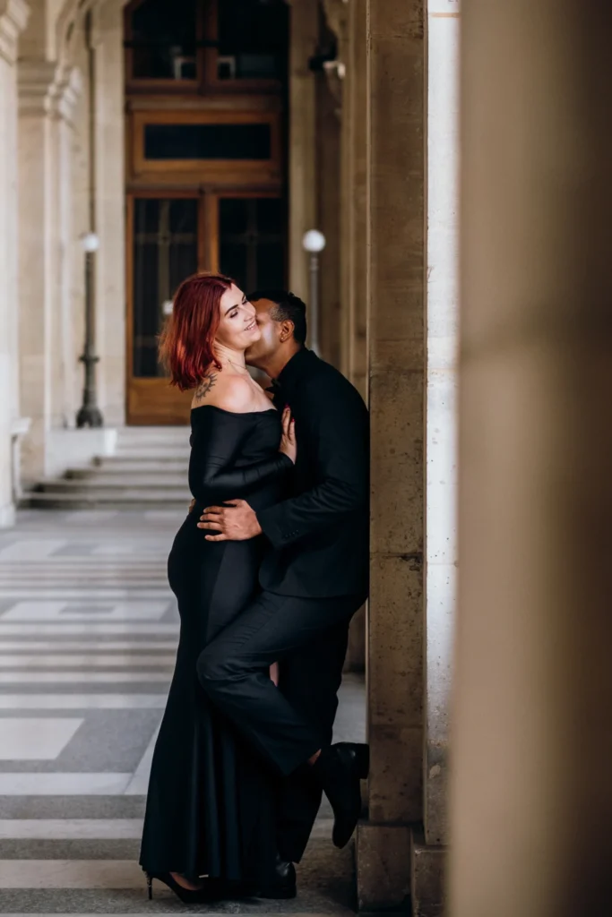 Elegant couple kissing at the Louvre museum