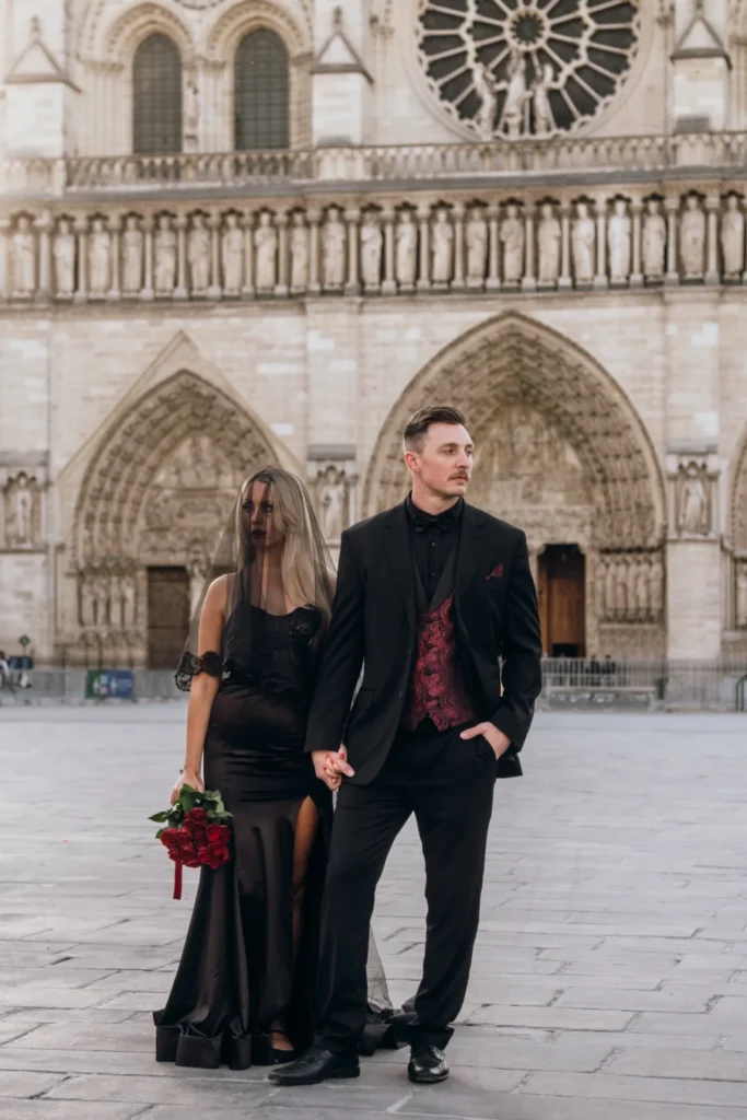 Goth couple standing in front of the Notre Dame Cathedral