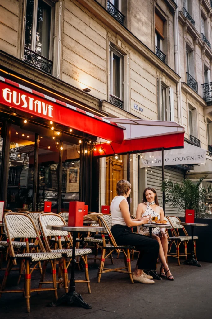 Same-sex couple sitting at a café in Paris